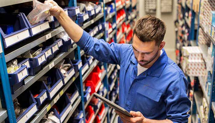 Service Technician reaching for parts