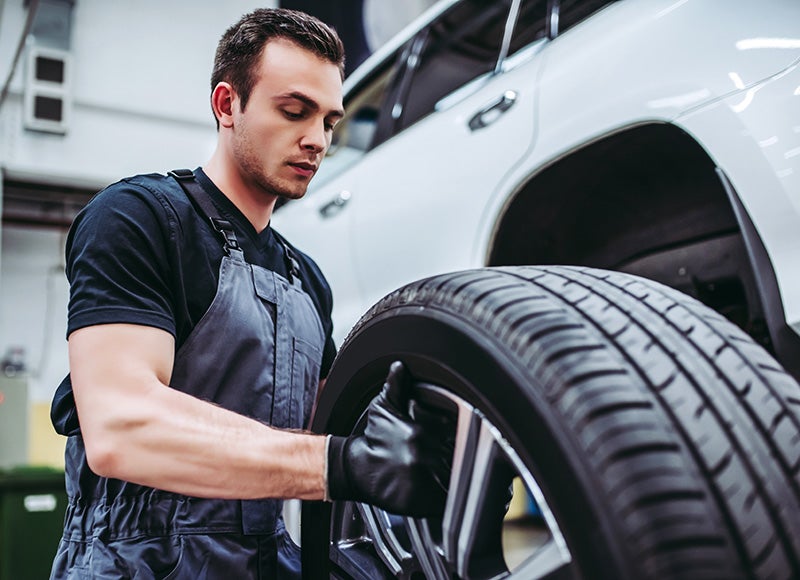 Service employee repairing a tire